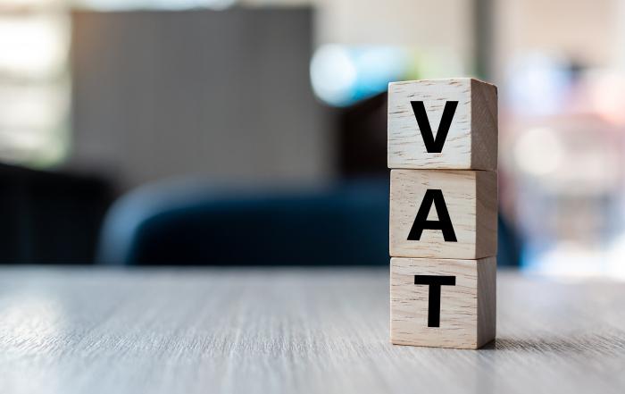 wooden cube with VAT text on table background. Financial, marketing and business concepts